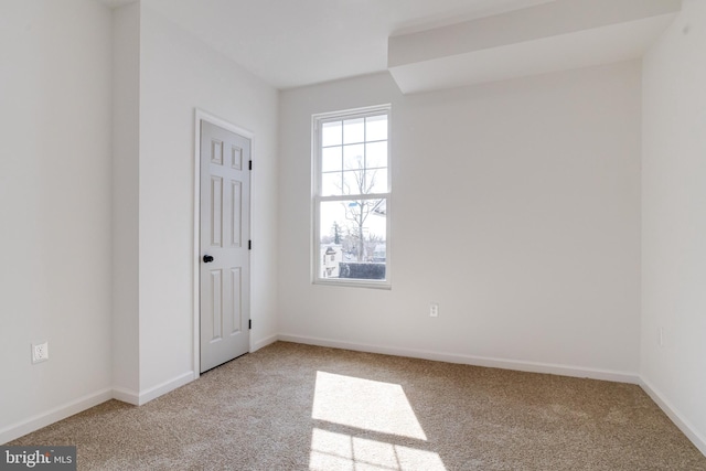 empty room with baseboards and carpet flooring