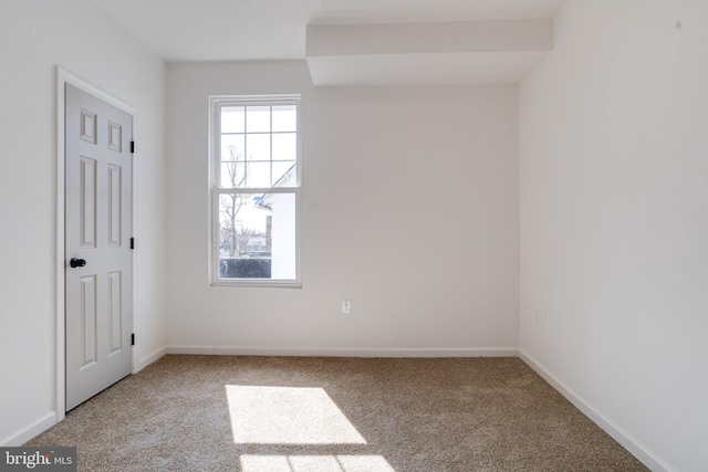 carpeted spare room with baseboards