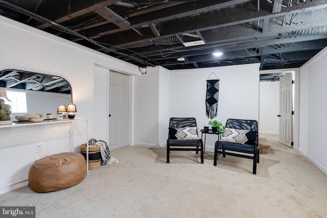 sitting room featuring carpet and baseboards