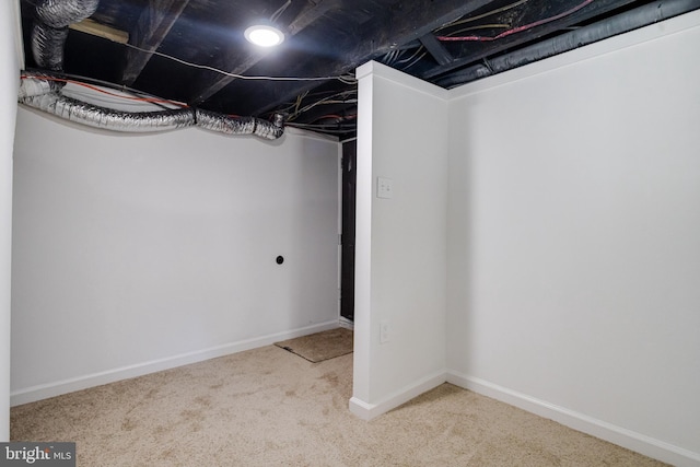 finished basement featuring baseboards and carpet