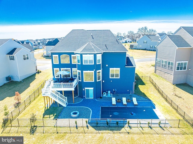 back of property with a yard, a patio, and a fenced backyard