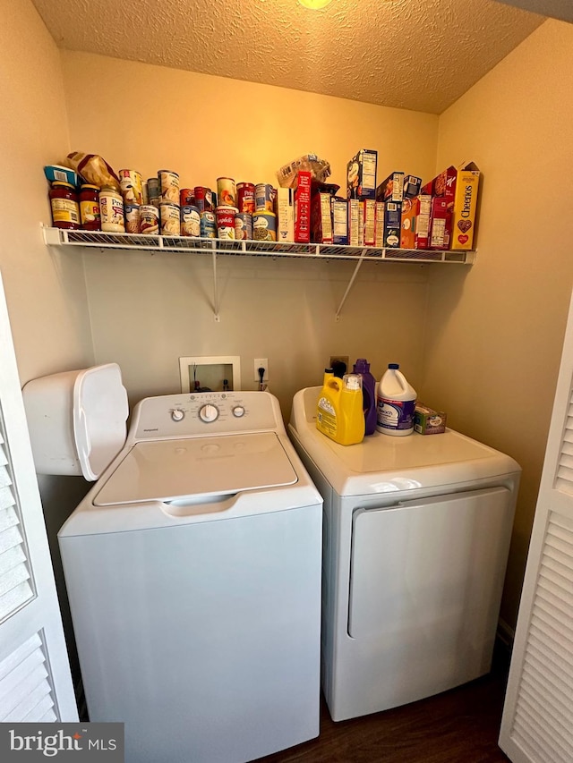 laundry area featuring laundry area, independent washer and dryer, a textured ceiling, and dark wood-type flooring