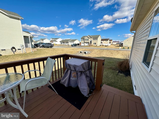 deck with a residential view and a lawn