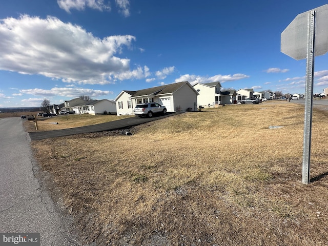 view of yard with a residential view and an attached garage