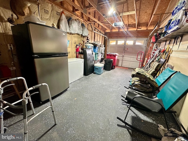 garage featuring a garage door opener, freestanding refrigerator, and fridge