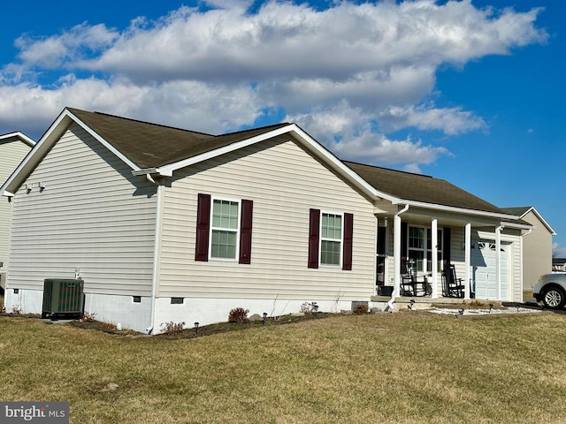 view of front of home with a front lawn, central air condition unit, a porch, crawl space, and an attached garage