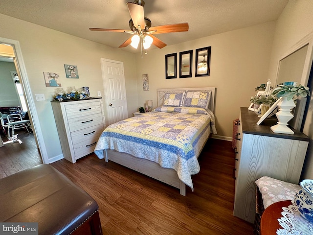 bedroom featuring ceiling fan, baseboards, a textured ceiling, and dark wood finished floors