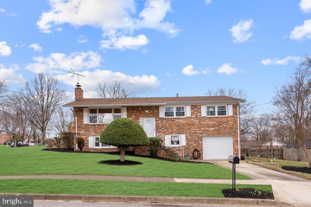 bi-level home with a front lawn, driveway, fence, a garage, and brick siding