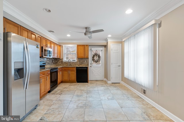 kitchen with black appliances, a sink, crown molding, stone counters, and decorative backsplash