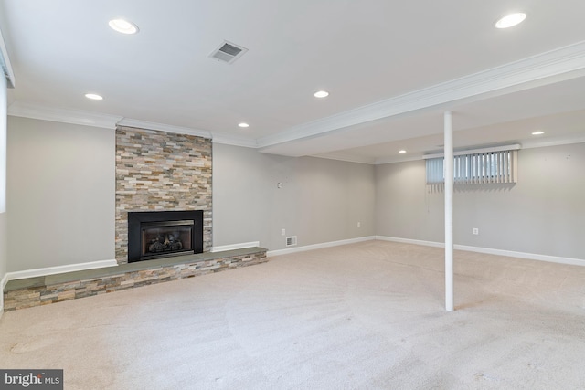 interior space with visible vents, ornamental molding, carpet flooring, baseboards, and a tile fireplace