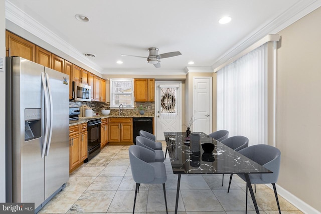 kitchen featuring brown cabinets, black appliances, ornamental molding, a sink, and tasteful backsplash