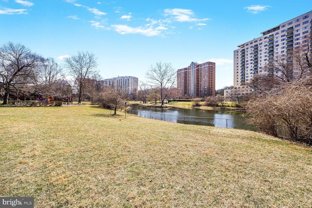 view of yard with a city view and a water view