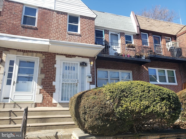 view of property featuring brick siding