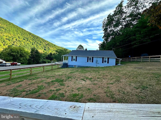 view of front of property with a front yard and fence