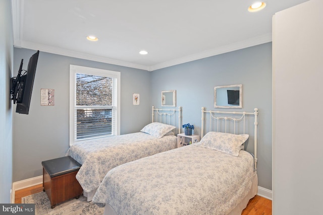 bedroom with light wood-type flooring, baseboards, and ornamental molding