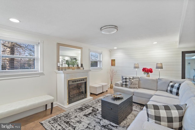 living room featuring recessed lighting, a fireplace, and baseboards