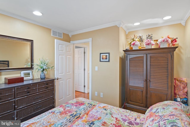 bedroom with crown molding, recessed lighting, and visible vents