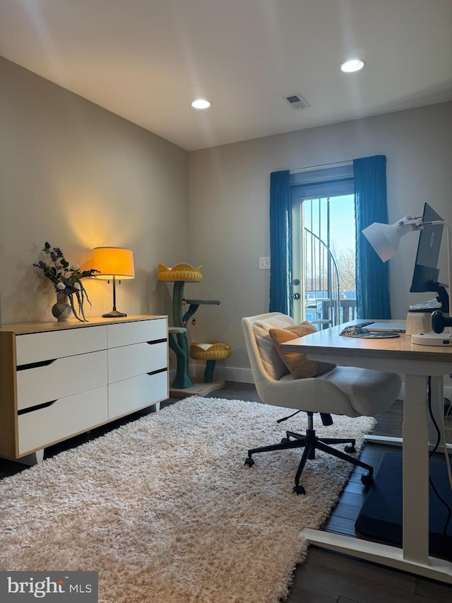 home office with recessed lighting, wood finished floors, visible vents, and baseboards