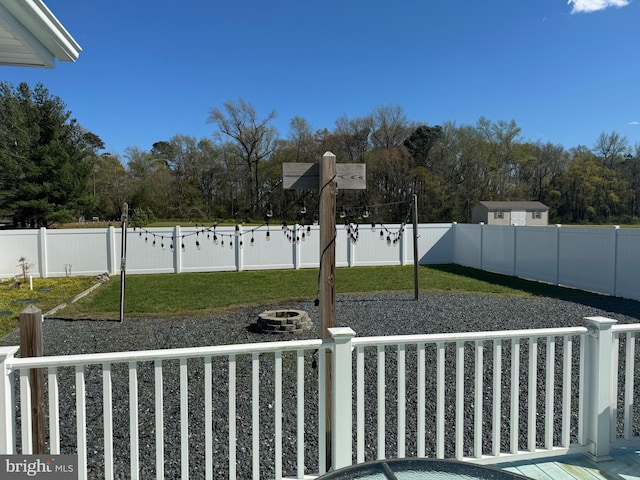 view of yard with a fire pit and a fenced backyard