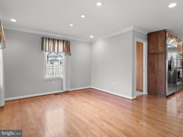 interior space featuring recessed lighting, baseboards, crown molding, and light wood finished floors