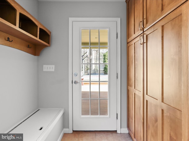 mudroom with light tile patterned flooring and baseboards