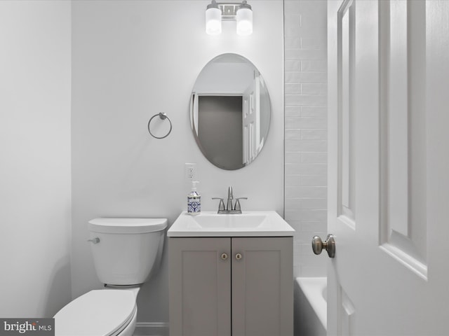 bathroom featuring vanity, toilet, and a bathing tub