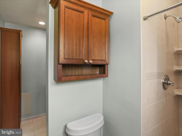 full bath with tile patterned flooring, toilet, recessed lighting, and a tile shower