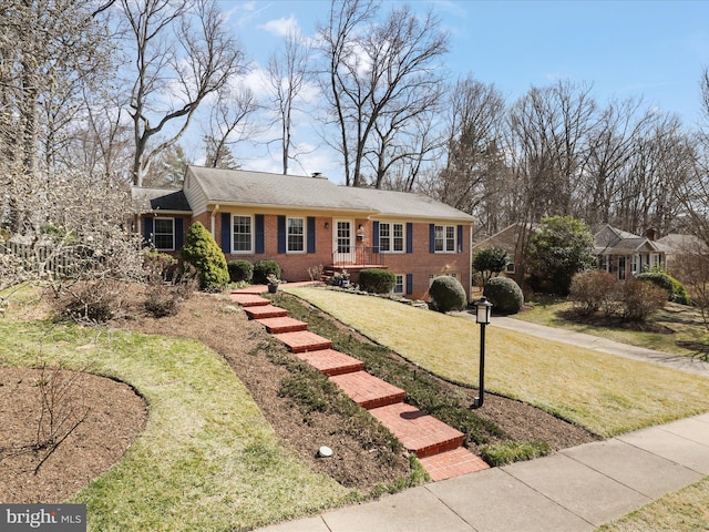 ranch-style home with a front lawn and brick siding