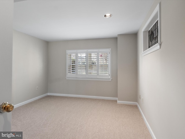 unfurnished room with baseboards and carpet flooring