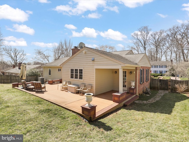 rear view of house with a lawn, cooling unit, a wooden deck, and fence