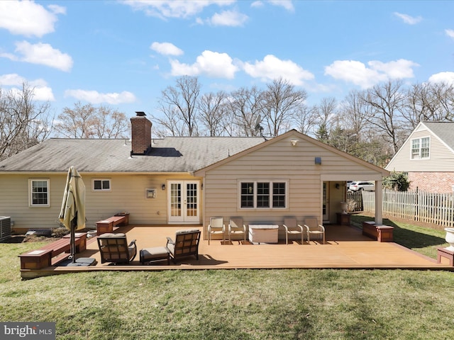 back of property featuring a yard, french doors, and fence