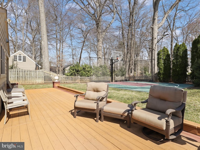 wooden deck featuring community basketball court and fence