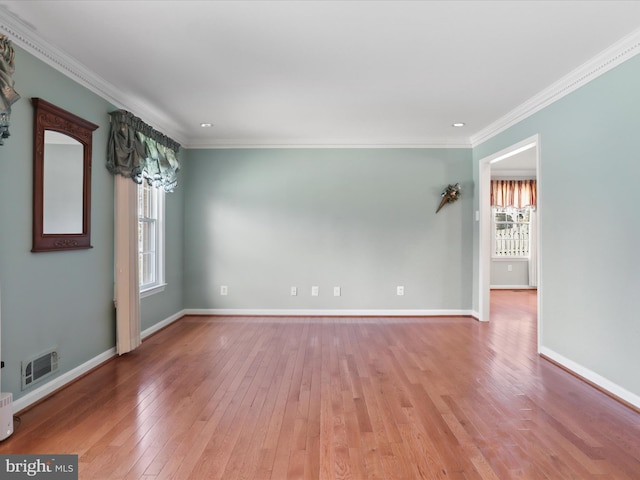 unfurnished room featuring a healthy amount of sunlight, baseboards, and hardwood / wood-style floors