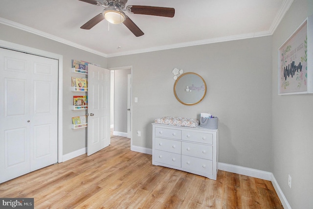 bedroom featuring ornamental molding, baseboards, and wood finished floors