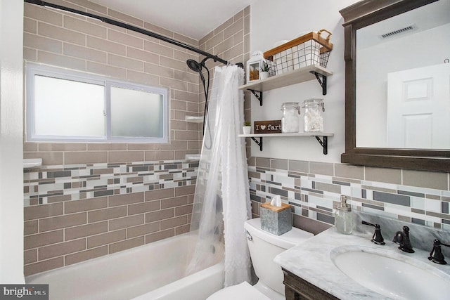 full bathroom featuring visible vents, backsplash, toilet, shower / bath combo, and tile walls