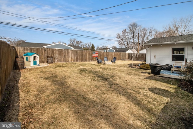 view of yard featuring a patio area, a fire pit, and a fenced backyard