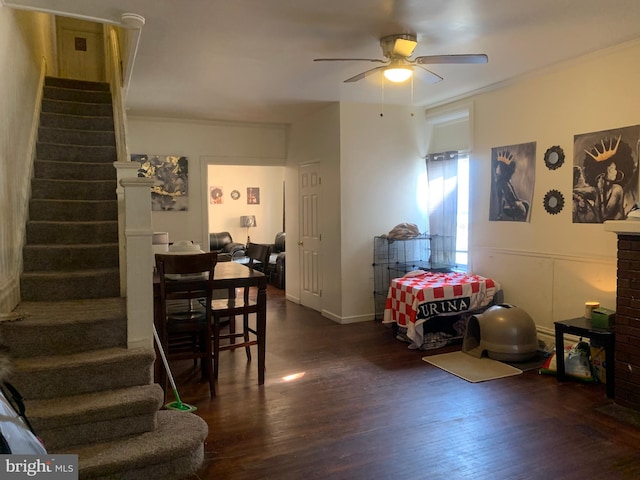 dining space with crown molding, stairway, and wood finished floors