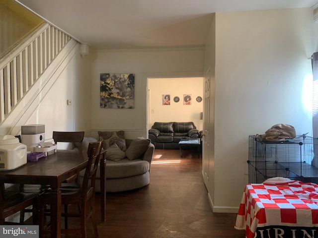 living area with stairs, dark wood-type flooring, and baseboards