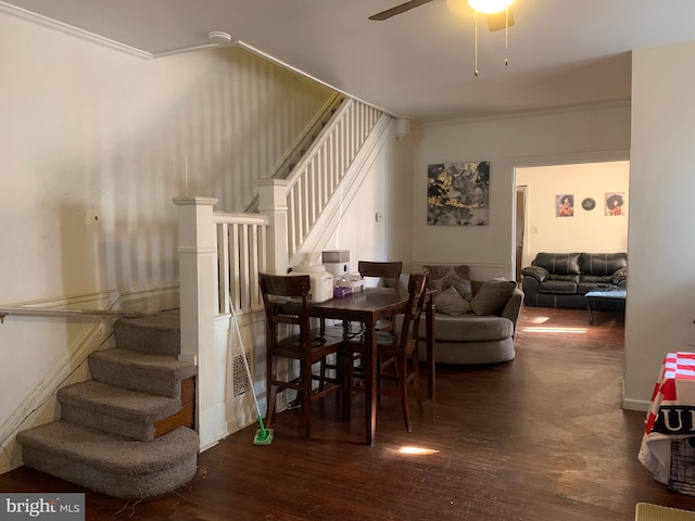 dining room featuring stairway, ornamental molding, wood finished floors, and ceiling fan