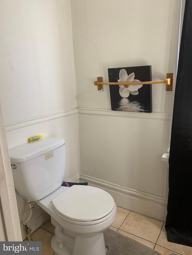 bathroom featuring toilet and tile patterned flooring