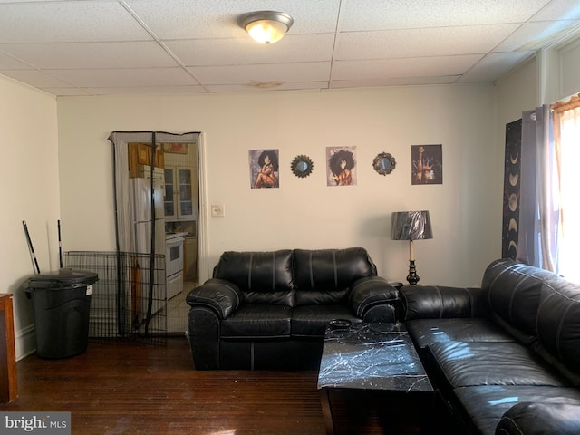 living room with a paneled ceiling and wood finished floors