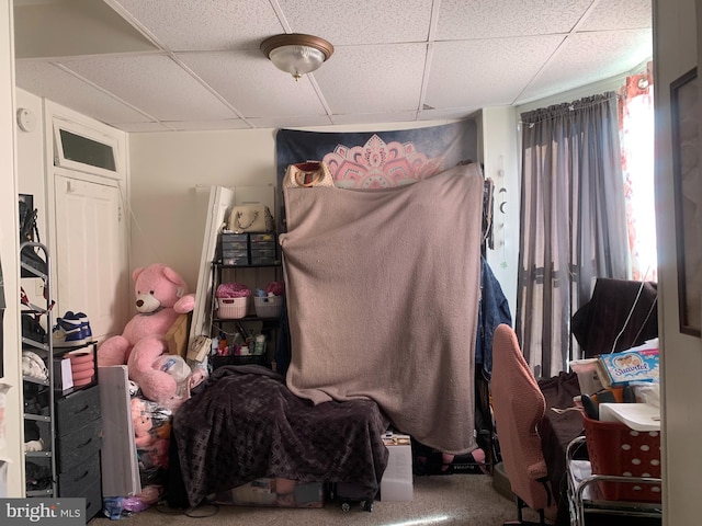 bedroom featuring a paneled ceiling and carpet