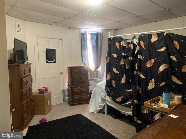 carpeted bedroom with a drop ceiling