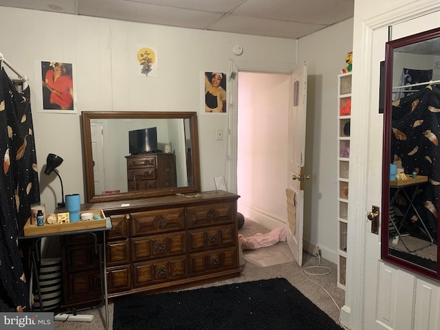 carpeted bedroom with a drop ceiling