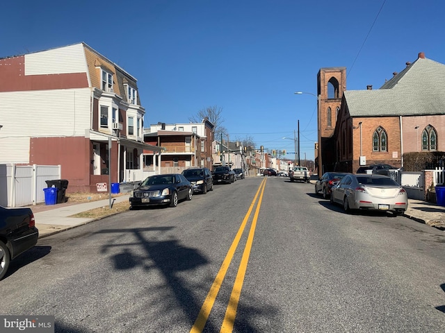 view of road with curbs, street lights, and sidewalks