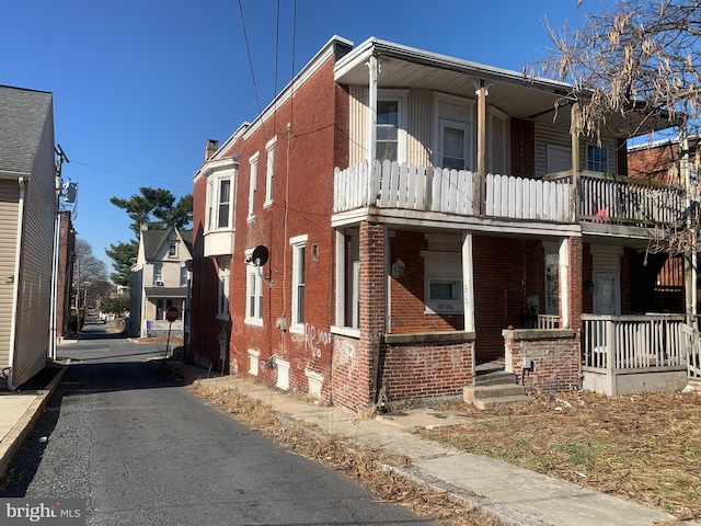 view of front of house with brick siding and a porch