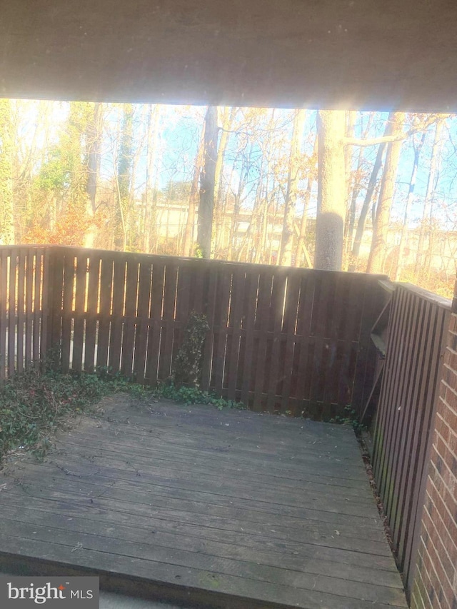 wooden terrace featuring fence