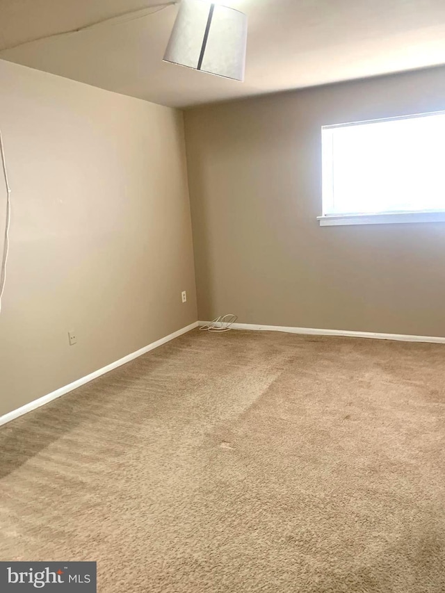 empty room with baseboards and carpet floors