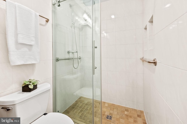 full bath with toilet and a stall shower