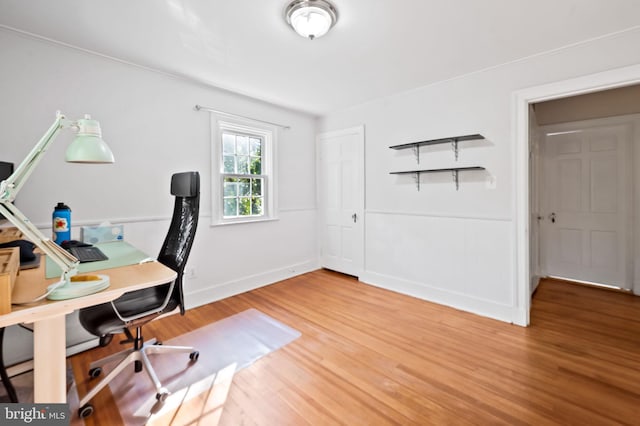 office area with baseboards and wood finished floors